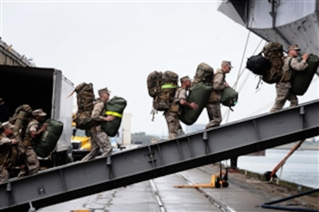 U.S. Marines embark aboard the multipurpose amphibious assault ship USS Bataan, Morehead City, N.C. March 28, 2011. The Bataan Amphibious Ready Group is deploying to the Mediterranean Sea. The Marines are assigned to the 22nd Marine Expeditionary Unit.