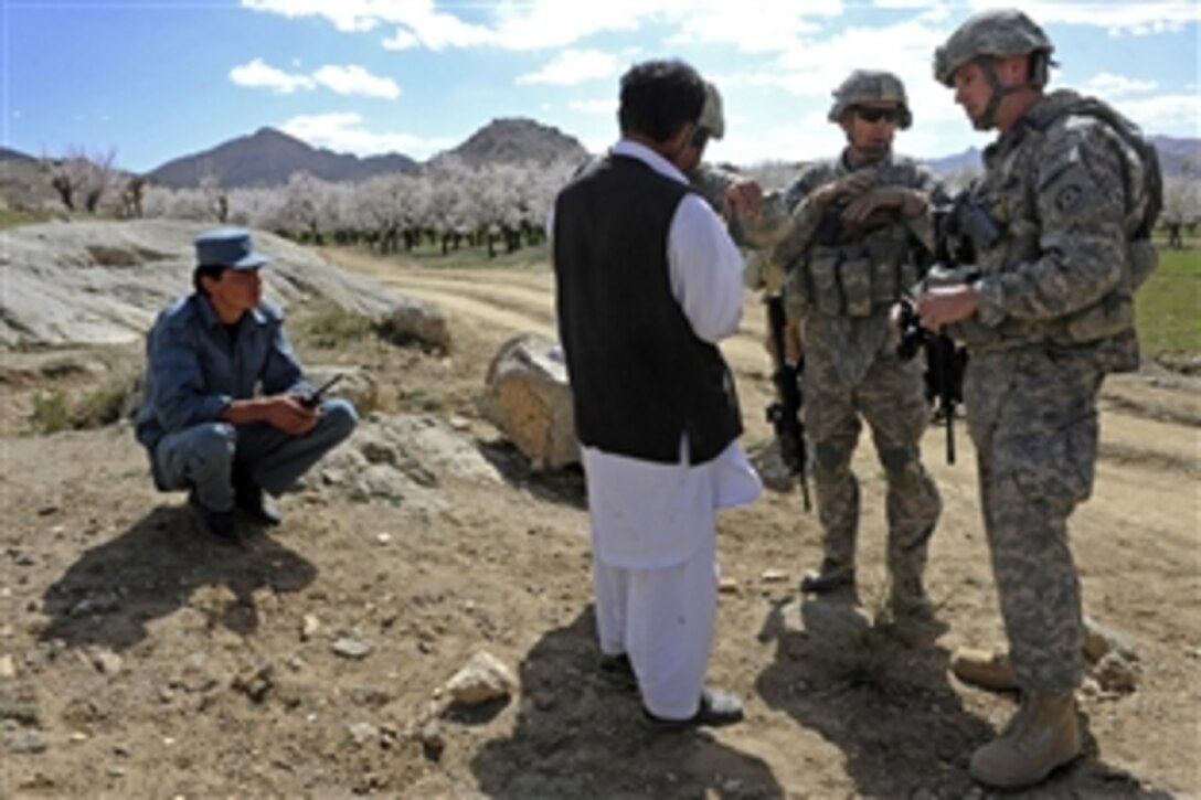 U.S. Air Force Commander Lt. Col. Andy Veres and Provincial Reconstruction Team Zabul senior engineer Capt. Christopher Bulson talk with a sub-contractor of the Daychopan district school, Zabul, Afghanistan, March 29, 2011. The school, currently under construction, should be completed this summer. 