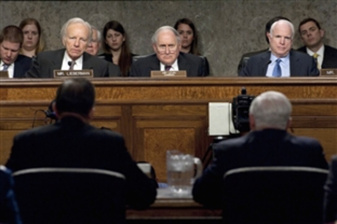 From left to right, Sens. Joseph Lieberman, Carl Levin and John McCain listen to Defense Secretary Robert M. Gates and Navy Adm. Mike Mullen, chairman of the Joint Chiefs of Staff, testify about operations in Libya during a Senate Armed Services Committee, Dirksen Senate Office Building, Washington, D.C., March 31, 2011.