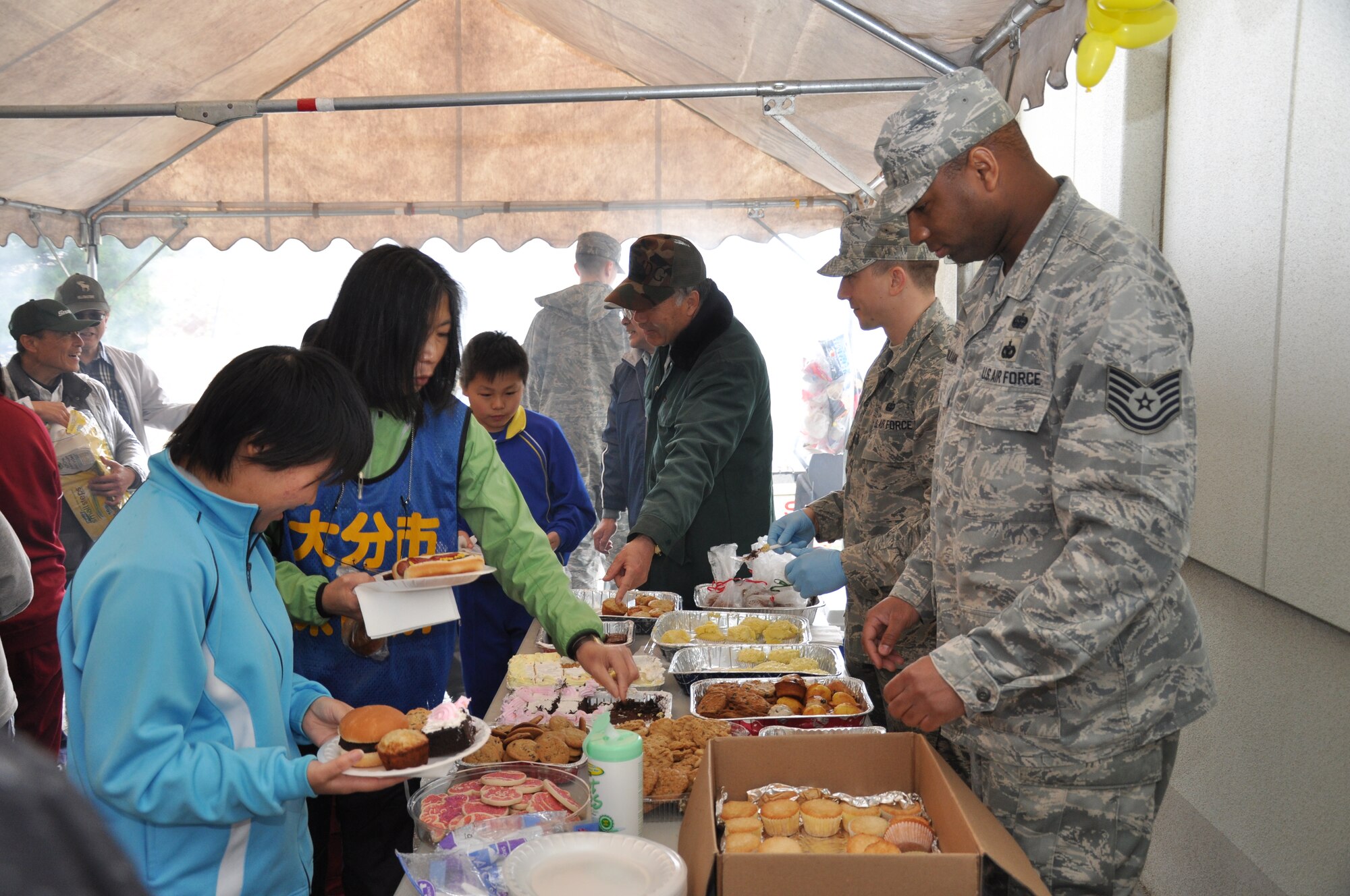 MISAWA AIR BASE, Japan -- Airmen from Misawa Air Base offer a variety of desserts to shelter residents in Miyako City April 23. While hamburgers and hot dogs were offered, Airmen said the desserts were the big hit among the Japanese. (U.S. Air Force photo/Staff Sgt. Clarence Armas)