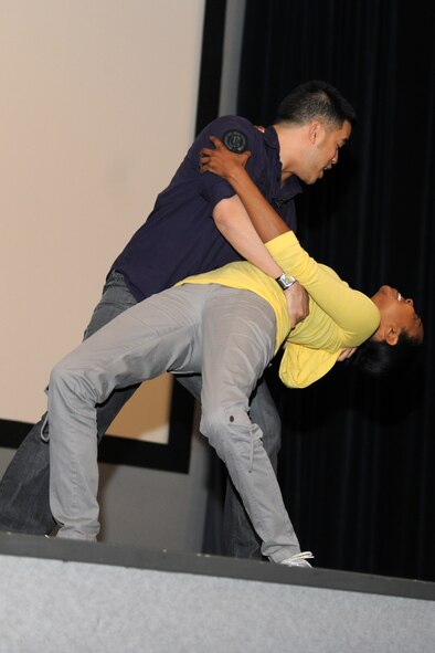 KUNSAN AIR BASE, Republic of Korea -- Sharyon Culberson and Eric Sumangil, both from Catharsis Productions, act out a scenario during the Sex Signals show here April 29. The presentation differs from traditional sexual assault prevention programs in that it incorporates improvisational comedy, education and audience interaction to provide a provocative look at dating, sex and the core issue of consent. (U.S. Air Force photo/Senior Airman Brittany Y. Bateman)