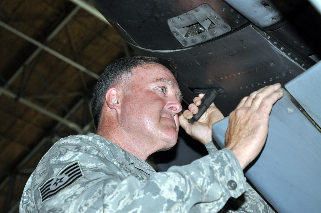 Tech. Sgt. Peter Terault, 446th Maintenance Squadron engine mechanic, checks a C-17 Globemaster III engine thrust reverser during a routine inspection at McChord Field.  The thrust reversers divert an aircraft engine's exhaust so that the thrust produced is directed forward, rather than aft. This acts against the forward travel of the aircraft, providing deceleration, slowing the aircraft after touch-down which reduces wear on the brakes and allows for shorter landing distances. Sergeant Terault is also a full time engine mechanic in his civilian job here.  (U.S. Air Force photo by Staff Sgt. Elizabeth Moody)