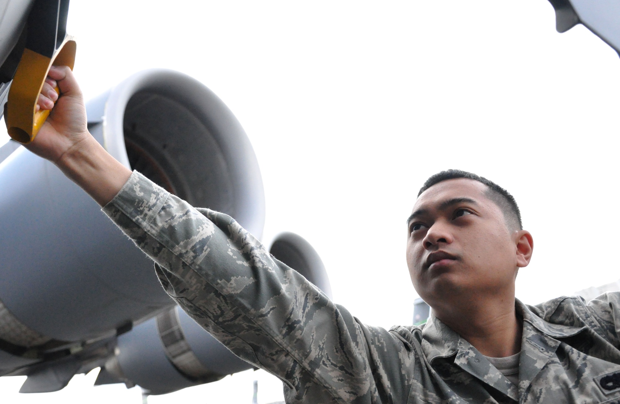 Air Force Senior Airman Eric Madlangbayan, an aircraft hydraulic technician journeyman with the 446th Aircraft Maintenance Squadron, McChord Field, Wash., deftly pulls the lever to open a C-17 Globemaster III aircraft troop door during his aircraft hydraulics inspection. Airman Madlangbayan described aircraft hydraulic technicians as a close-knit team, because they work in high pressure settings, and have to have strong communication skills. (U.S. Air Force Photo/SSgt. Nicole Celestine)