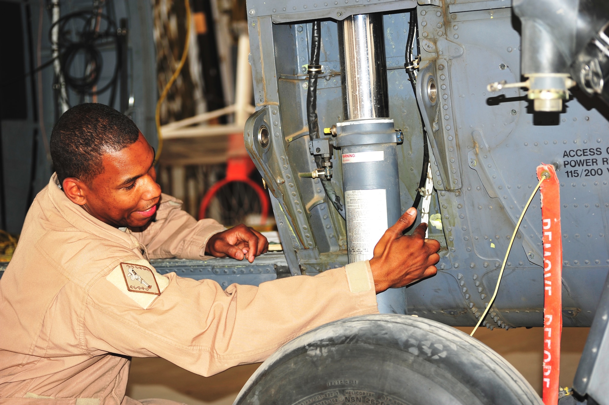 Staff Sgt. William Gonzalez, 83rd Expeditionary Rescue Squadron gunner, shows where a bullet impacted the side of his HH-60G Pavehawk.  The Airmen came under heavy fire during a mission to recover the pilots of a downed Army helicopter, April 23, 2011.  (U.S. Air Force photo by Capt. Erick Saks)