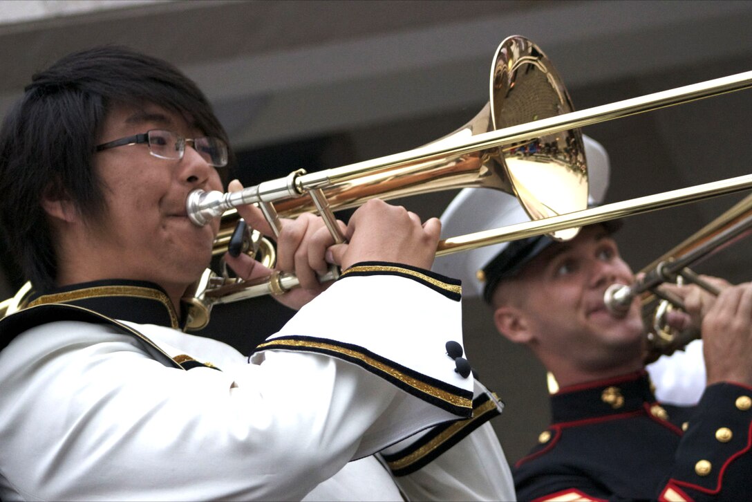Sgt. Matt Jeremy, trumpet player, U.S. Marine Corps Forces, Pacific Band, teaches techniques to high school student during their first ever visit to China.