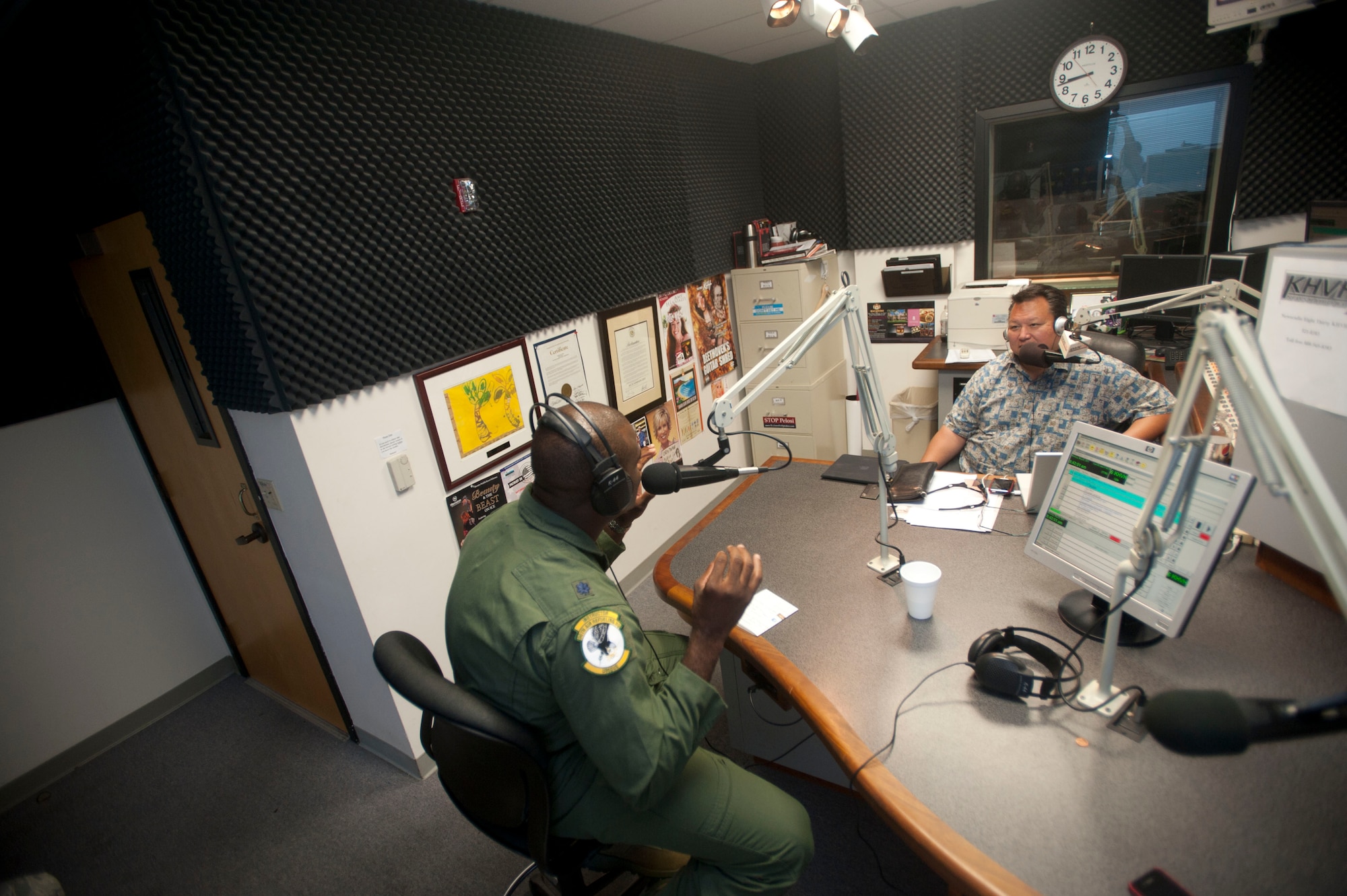 Lt. Col. Brian Hill, 96th Air Refueling Squadron commander, speaks to Rick Hamada, KHVH-AM 830 radio personality, for Military Appreciation Month May 2, 2011. Colonel Hill's interview kicked off one of many Air Force interviews that will be conducted this month to highlight military members through out the month of May. Colonel Hill spoke about his career, why he joined, the Airmen he works with and family. (U.S. Air Force photo/Airman 1st Class Lauren Main)