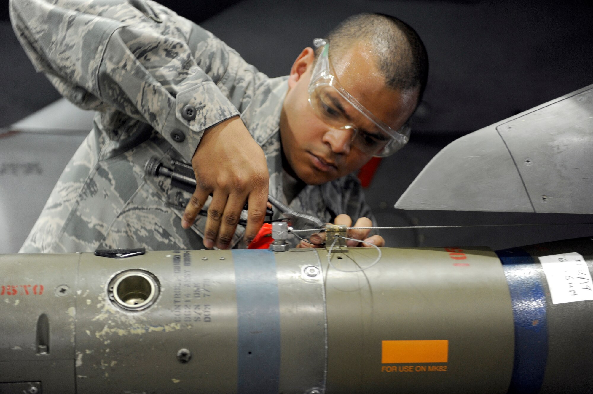 MISAWA AIR BASE, Japan -- Airman 1st Class Robert Flowers-Velaquez, 14th Aircraft Maintenance Unit weapons load crew member, safety wires a Guided Bomb Unit-12 April 29. Each competing team starts with 2000 points and the winner is determined by total points, not the time it takes to complete the load. (U.S. Air Force photo/Staff Sgt. Marie Brown/Released)
