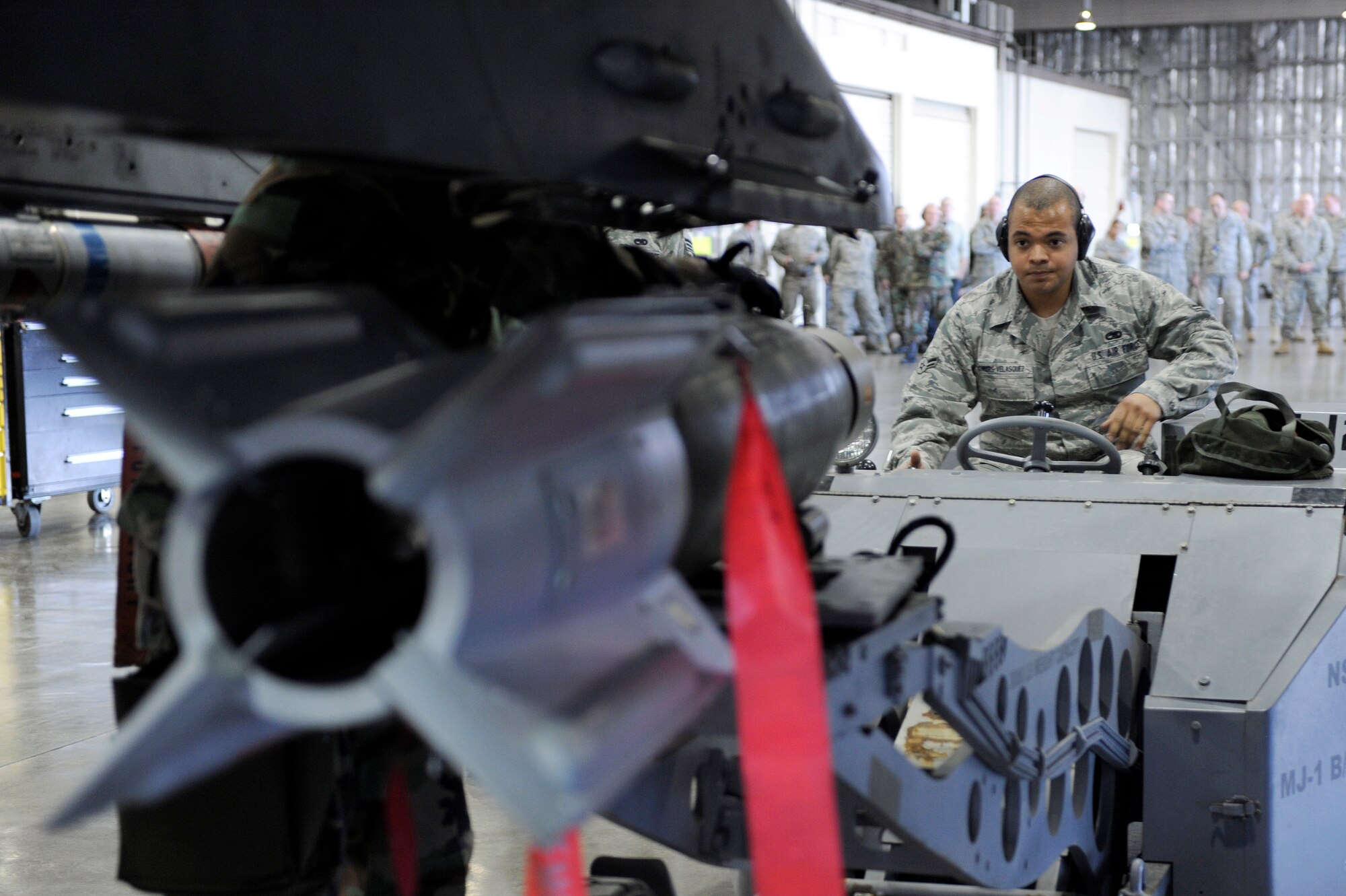 MISAWA AIR BASE, Japan -- Airman 1st Class Robert Flowers-Velasquez, 14th Aircraft Maintenance Unit weapons load crew member, ensures a Guided Bomb Unit-12 is properly placed using an MJ-1 lift truck April 29. The MJ-1, also called a "jammer," is used to load and unload a wide variety of munitions and has a lifting capacity of 3,000 pounds. (U.S. Air Force photo/Staff Sgt. Marie Brown/Released)

