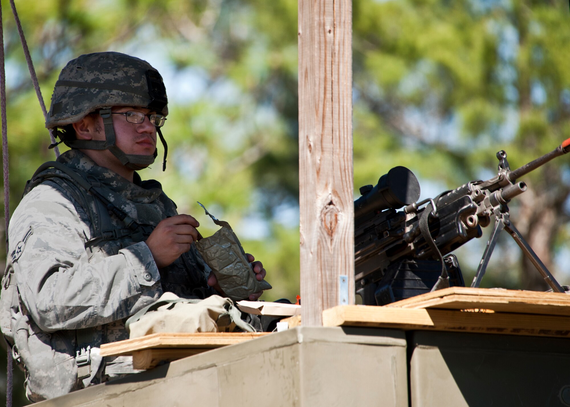 An Airman enjoys a snack while pulling a shift in one of the many towers posted along the perimeter of Base Tango during an exercise April 28 at Eglin Air Force Base, Fla.  The exercise was part of Air Force Materiel Command’s "Brave Defender" training, which is administered by the 96th Ground Combat Training Squadron.  ECP guards experienced random vehicle inspections, media visits and VBIEDs during posted shifts.   GCTS instructors push 10 training classes a year, which consists of IED detection and reaction, operating in an urban environment, mission planning, land navigation and casualty care.  The three-week training culminates with a three-day field training exercise where the Airmen apply what they learned in combat scenarios.  More than 140 Airmen from more than 10 locations attended this training.  (U.S. Air Force photo/Samuel King Jr.)