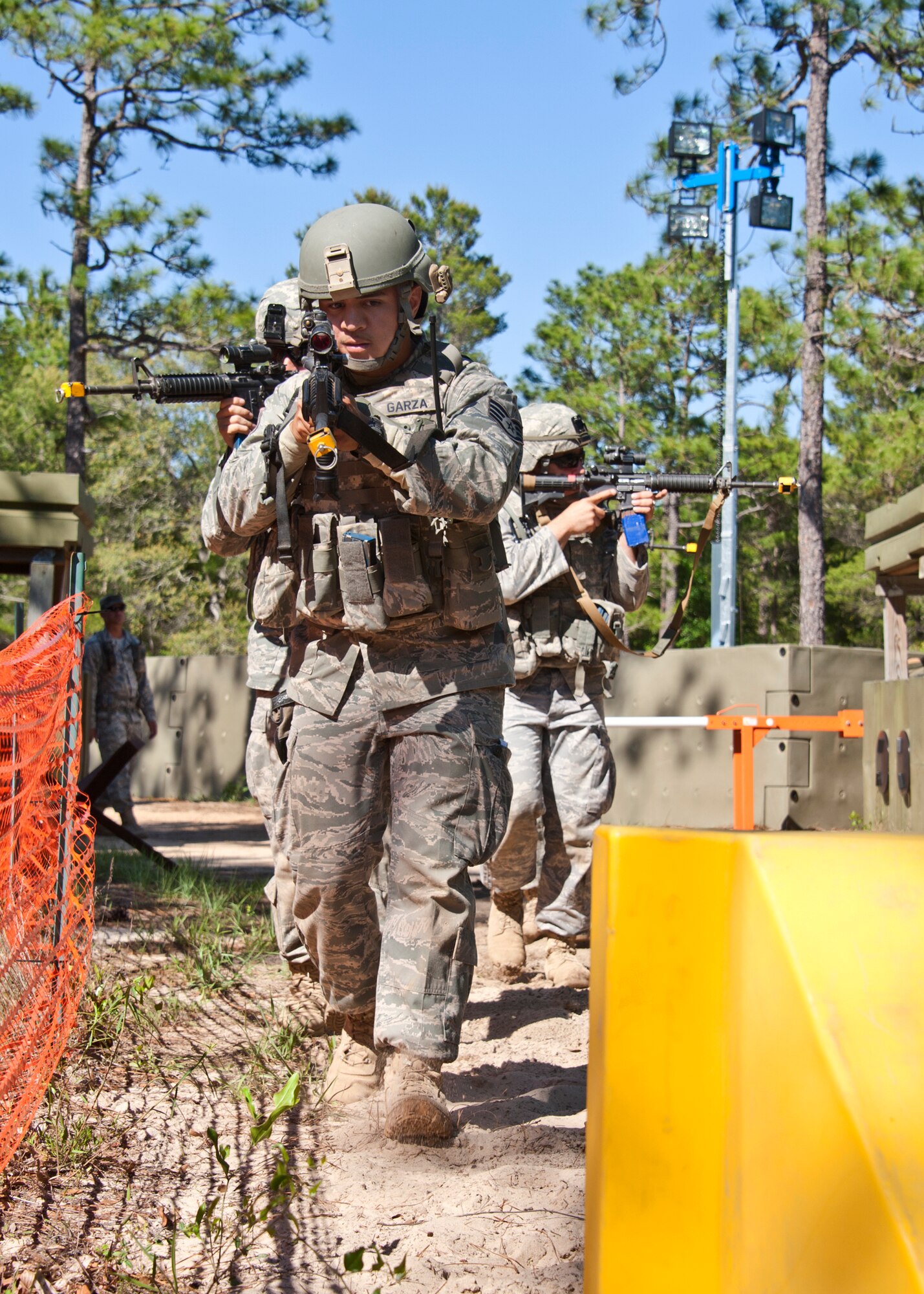 Staff Sgt. Eric Garza, 10th Security Forces Squadron, leads the quick response force toward the site of a vehicle-borne improvised explosive device detonation during an exercise April 28 at Eglin Air Force Base, Fla.   This was part of Air Force Materiel Command’s "Brave Defender" training, which is administered by the 96th Ground Combat Training Squadron.  ECP guards experienced random vehicle inspections, media visits and VBIEDs during posted shifts.   GCTS instructors push 10 training classes a year, which consists of IED detection and reaction, operating in an urban environment, mission planning, land navigation and casualty care. The three-week training culminates with a three-day field training exercise where the Airmen apply what they learned in combat scenarios.  More than 140 Airmen from more than six major commands attended this training.  (U.S. Air Force photo/Samuel King Jr.)