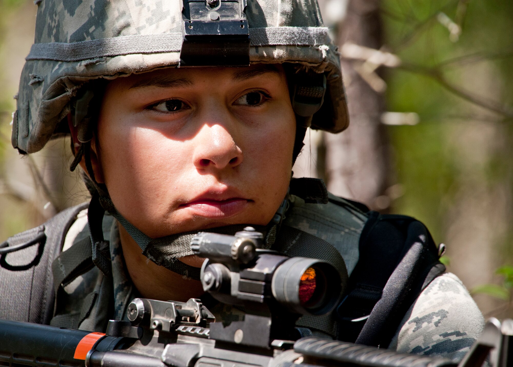 A security forces Airman watches and waits as her squad regroups and debriefs during an ‘outside the wire’ exercise April 28 at Eglin Air Force Base, Fla.  This was part of Air Force Materiel Command’s "Brave Defender" training, which is administered by the 96th Ground Combat Training Squadron.   The goal for their exercise was to use land navigation techniques to find a weapons cache based on the intelligence they were given.  GCTS instructors push 10 training classes a year, which consists of improvised explosive device detection and reaction, operating in an urban environment, mission planning, land navigation and casualty care.  The three-week training culminates with a three-day field training exercise where the Airmen apply what they learned in combat scenarios.  More than 140 Airmen from more than 12 locations attended this training.  (U.S. Air Force photo/Samuel King Jr.)