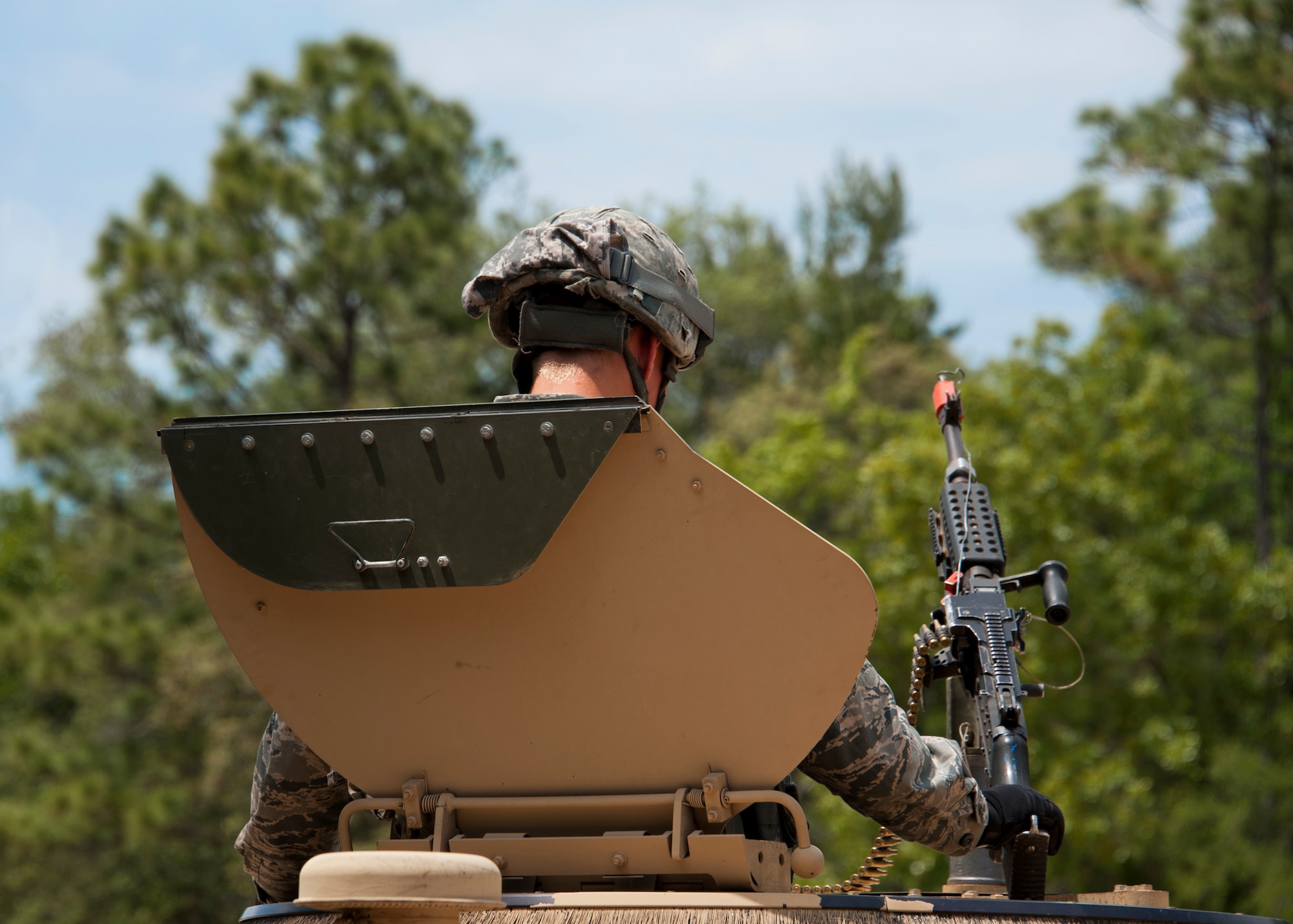 A security forces Airman waits in the turret seat of a humvee to roll out on a ‘mounted’ vehicle mission outside the wire as part of an exercise April 28 at Eglin Air Force Base, Fla.  This was part of Air Force Materiel Command’s "Brave Defender" training, which is administered by the 96th Ground Combat Training Squadron.  Teams of Airmen experienced both mounted (vehicle) and dismounted (foot) patrols through the forests and simulated villages around their base.  GCTS instructors push 10 training classes a year, which consists of improvised explosive device detection and reaction, operating in an urban environment, mission planning, land navigation and casualty care. The three-week training culminates with a three-day field training exercise where the Airmen apply what they learned in combat scenarios.  More than 140 Airmen from more than six major commands attended this training.  (U.S. Air Force photo/Samuel King Jr.)