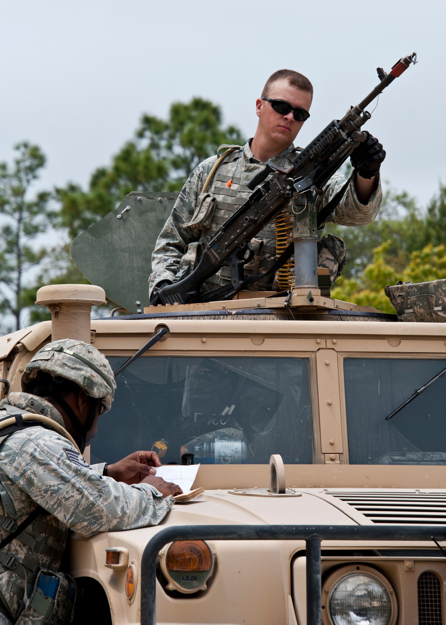 A security forces Airman prepares his M60 turret before a ‘mounted’ vehicle mission outside the wire during an exercise April 27 at Eglin Air Force Base, Fla.  This was part of Air Force Materiel Command’s "Brave Defender" training, which is administered by the 96th Ground Combat Training Squadron.   Teams of Airmen experienced both mounted (vehicle) and dismounted (foot) patrols through the forests and simulated villages around their base.   GCTS instructors push 10 training classes a year, which consists of improvised explosive device detection and reaction, operating in an urban environment, mission planning, land navigation and casualty care. The three-week training culminates with a three-day field training exercise where the Airmen apply what they learned in combat scenarios.  More than 140 Airmen from more than 12 locations attended this training.  (U.S. Air Force photo/Samuel King Jr.)