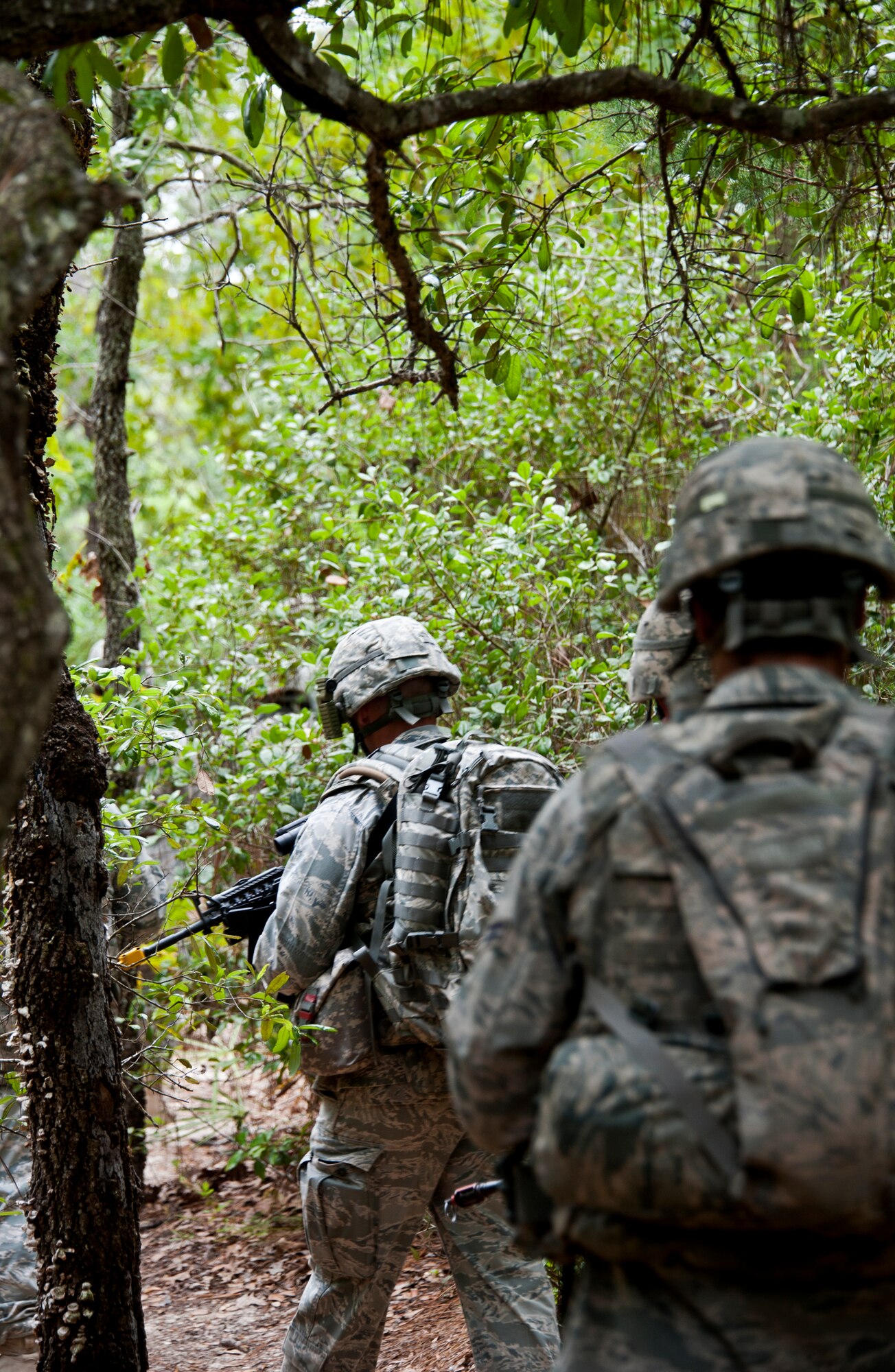 A squad of security forces Airmen patrol the forests ‘outside the wire’ during simulated mission April 27 at Eglin Air Force Base, Fla.  This was part of Air Force Materiel Command’s "Brave Defender" training, which is administered by the 96th Ground Combat Training Squadron.  GCTS instructors push 10 training classes a year, which consists of improvised explosive device detection and reaction, operating in an urban environment, mission planning, land navigation and casualty care.More than 140 Airmen from more than 12 locations attended this training.  (U.S. Air Force photo/Samuel King Jr.)