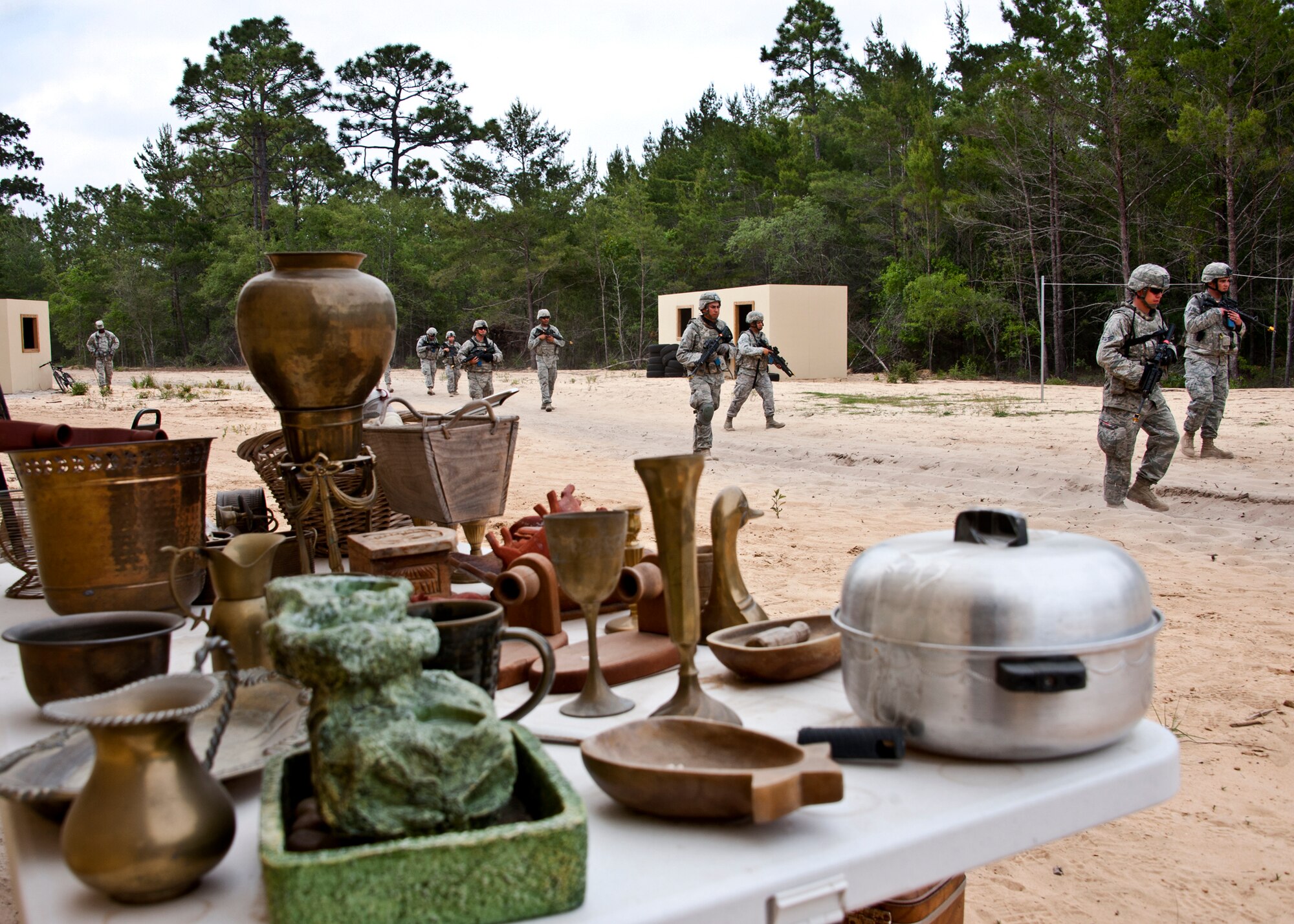 A squad of security forces Airmen passes through a simulated village on a counter-insurgency mission April 27 at Eglin Air Force Base, Fla.  More than 140 Airmen from more than 12 locations attended Air Force Materiel Command’s "Brave Defender" training, which is administered by the 96th Ground Combat Training Squadron.  GCTS instructors push 10 training classes a year, which consists of improvised explosive device detection and reaction, operating in an urban environment, mission planning, land navigation and casualty care. (U.S. Air Force photo/Samuel King Jr.)