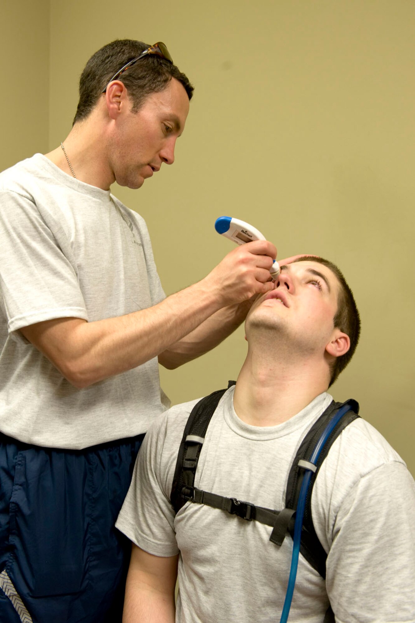 HAYNEVILLE, Ala. - Capt. Andrew Adamich, an optometrist from the 176th Medical Group, Alaska Air National Guard, performs an equipment test on Airman Aaron Brehm, an optometry technician, also with the medicial group, May 1, 2011.  Adamich is doing a inner ocular pressure test which helps in screening for glaucoma and for the early signs of the disease. Adamich and Brehm and about 30 other members from the 176th Wing are in Alabama for an Innovative Readiness Training (IRT) mission. The IRT program allows for real world training opportunities for military personnel while providing needed services to under-served communities in the United States. The Shower kits will be used by the men of the group during the 10-day mission.  Alaska Air National Guard photo by Master Sgt. Shannon Oleson.
