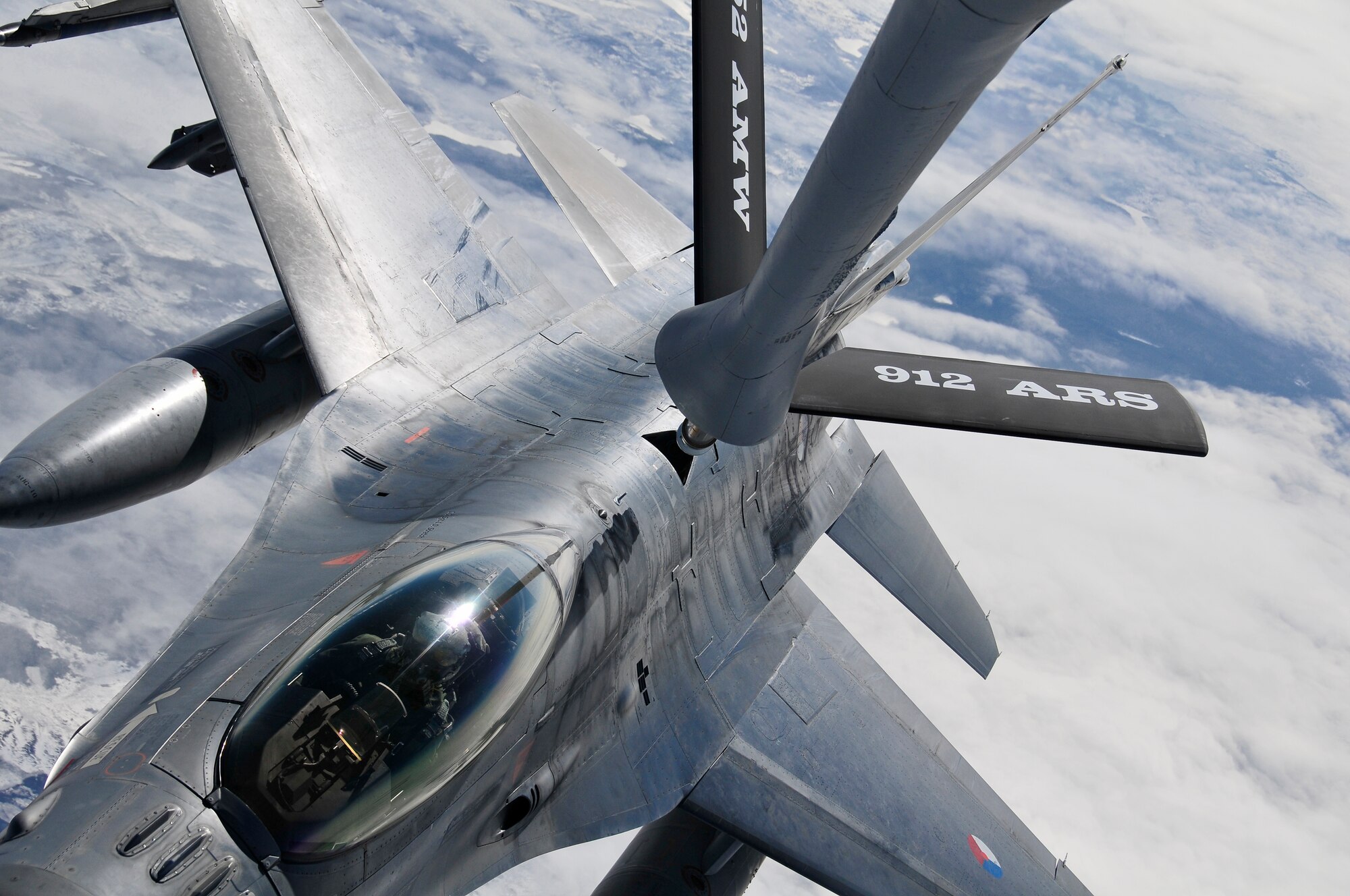 A KC-135 Stratotanker from Fairchild Air Force Base, Wash. provides aerial refueling to an F-16A from Leeuwarden Air Base, Netherlands over the Joint Pacific Alaska Range Complex during RED FLAG-Alaska 11-1, April 28, 2011.  The JPARC covers more than 67,000 square miles and enables the military to have the largest air-ground training complex in America.  (U.S. Air Force photo/Staff Sgt. Miguel Lara III)

