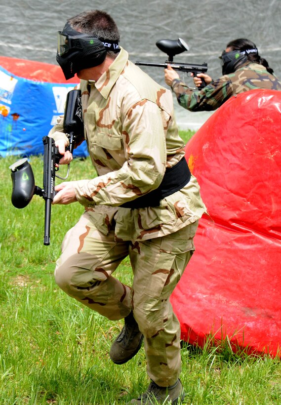 Major Steven Ammons, 11th Wing Plans and Programs director, left, and Randy Sena, 11 XP chief of exercises, participate in a paintball game during the Paintball Season Opener hosted by Outdoor Recreation April 29 at the paintball field. The event had free play, food, and prizes for the participants.  (U.S. Air Force Photo/ Airman 1st Class Bahja J. Jones) 