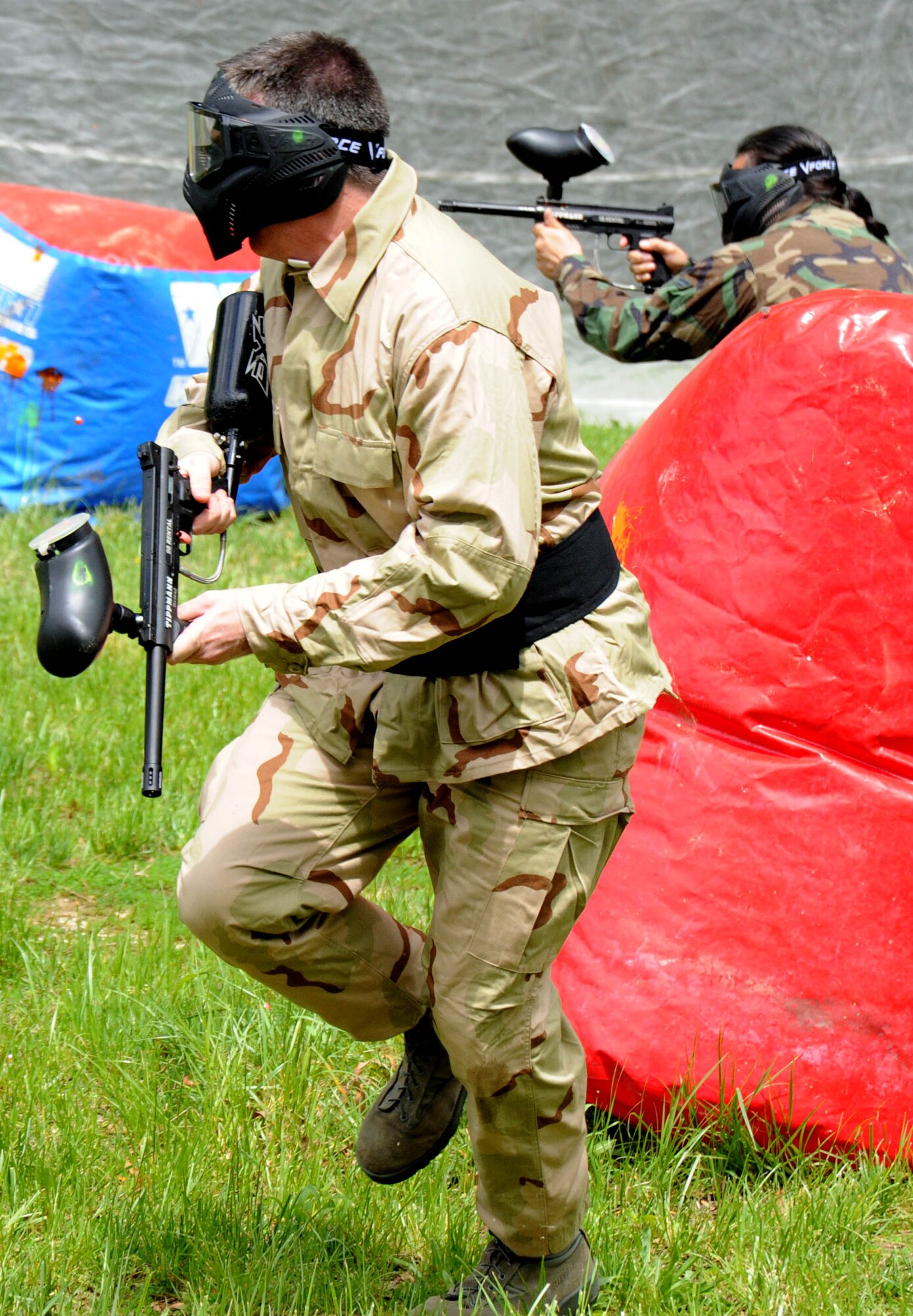 Major Steven Ammons, 11th Wing Plans and Programs director, left, and Randy Sena, 11 XP chief of exercises, participate in a paintball game during the Paintball Season Opener hosted by Outdoor Recreation April 29 at the paintball field. The event had free play, food, and prizes for the participants.  (U.S. Air Force Photo/ Airman 1st Class Bahja J. Jones) 