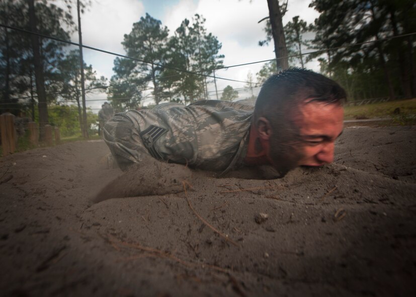 CAMP BLANDING, Fla.-- Staff Sgt. Jonathan Smith, 820th  Communication Operations Squadron NCO in charge of training, gets a mouthful of dirt while low crawling through sand April 27. Every Airman was encouraged to complete each station to their full ability while getting words of motivation at every station. (U.S. Air Force photo/Airman 1st Class Joshua Green)(RELEASED)
