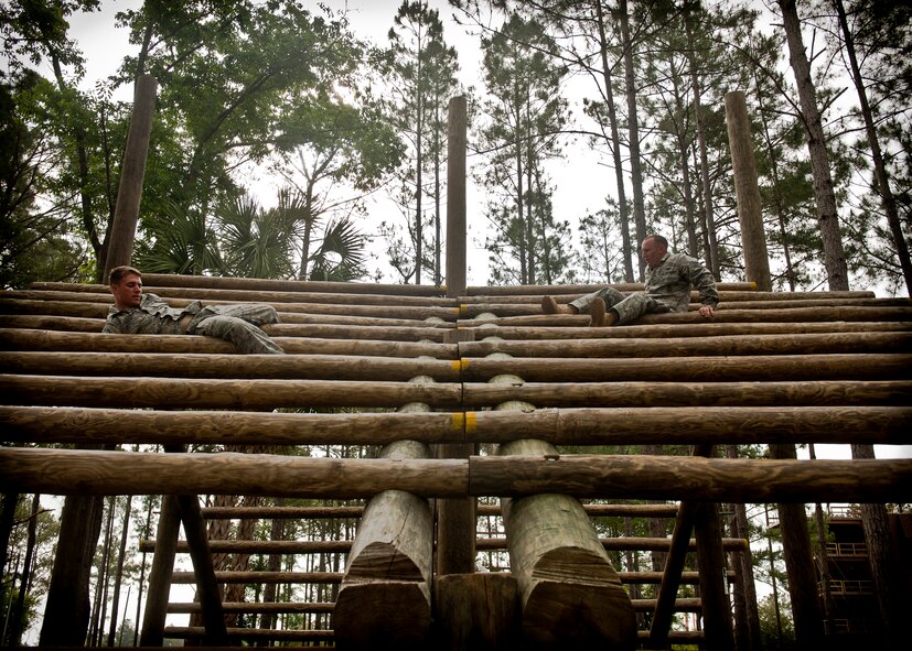 CAMP BLANDING, Fla.-- Two Airmen from 823rd Base Defense Squadron weave in and out of logs slanted at an angle while participating in an obstacle course April 27. At the Army Air Assault School, Airmen learn air assault helicopter operations, aircraft orientation, slingload operations, proper rappelling techniques and fast-rope techniques. (U.S. Air Force/Airman 1st Class Joshua Green)(RELEASED)
