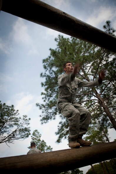 CAMP BLANDING, Fla.-- Senior Airman Jacob Thompson, 823rd Base Defense Squadron fireteam member, prepares to leap onto a log while  attempting to complete an obstacle course station April 27. The obstacle course was designed to assess upper body strength, agility, endurance, confidence and the ability to perform at heights without displaying fear or distress. (U.S. Air Force photo/Airman 1st Class Joshua Green)(RELEASED)
