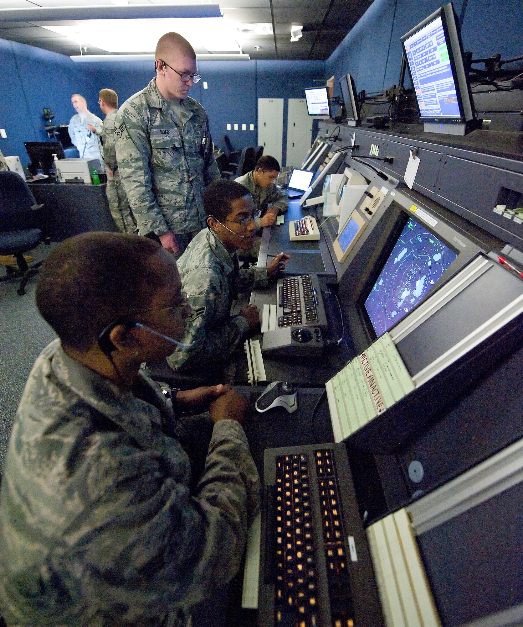 Air traffic controllers with the 436th Operations Support Squadron Radar Approach Control, guide planes through the eight airways they control from sea level to 7,000 feet in the air April 27, 2011 Dover Air Force Base, Del. The system they use monitors all planes, including civilian aircraft coming through RAPCON’s airspace. (U.S. Air Force photo by Roland Balik)