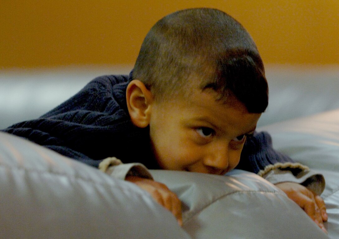 Adrian Alcantara, son of Tech. Sgt. Manual Alcantara, 28th Maintenance Squadron team leader, takes a break from running in an inflatable jumping castle at the Dakota’s Club at Ellsworth Air Force Base, S.D., April 29. The castle was one of the attractions that made up the club-sponsored Family Fun Day. (U.S. Air Force photo by Senior Airman Jarad A. Denton)