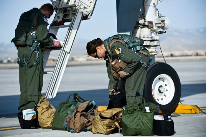 NELLIS AIR FORCE BASE, Nev. --  Capt. Curtis Michael and Capt. Kristen Jenkins, B-1 Lancer pilots, 28th Bomb Wing, Ellsworth AFB, S.D., perform preflight checks before a training mission at Nellis Air Force Base, Nev., during exercise Green Flag West 11-6, April 28. Green Flag West replicates irregular warfare conditions currently found in Southwest Asia. Aircrews, work closely with Air Force joint terminal attack controllers. Pilots train for a missions such as close air support, and aerial reconnaissance.(U.S. Air Force photo by Senior Airman Brett Clashman)