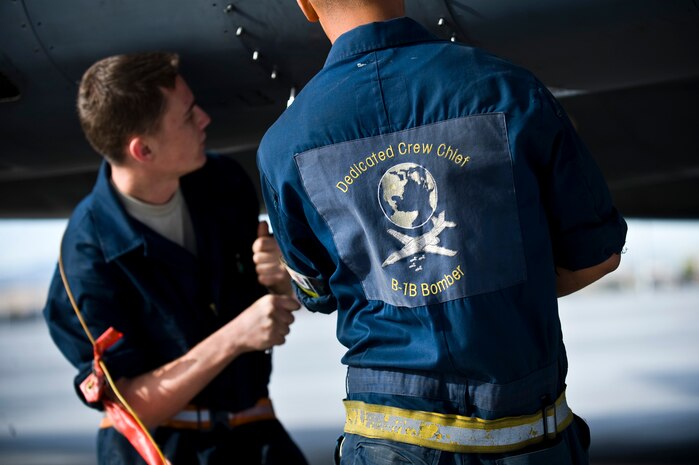 NELLIS AIR FORCE BASE, Nev. --  Staff Sgt. William Hatten and Airman 1st Class Mindenhall, crew chiefs from the 28th Aircraft Maintenance Squadron, Ellsworth AFB, S.D., unscrew a panel on a B-1B Lancer at Nellis Air Force Base, Nev., during exercise Green Flag West 11-6, April 28. Green Flag West replicates irregular warfare conditions currently found in Southwest Asia. Aircrews, work closely with Air Force joint terminal attack controllers. Pilots train for a missions such as close air support, and aerial reconnaissance.(U.S. Air Force photo by Senior Airman Brett Clashman)