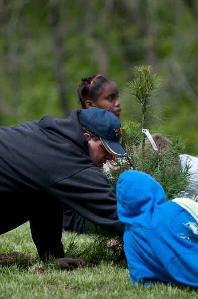 Fifth graders from Hyde elementary school, plant trees along the parkway with members of the 139th Airlift Wing, in Saint Joseph Mo., April 29, 2011. The tree planting is part of the annual earth day activates with the St. Joseph school district. (U.S. Air Force photo by Senior Airman Sheldon Thompson/Released)