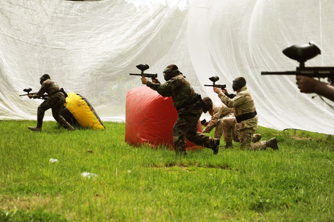 Paintball warriors from the 11th Wing Plans and Programs office spring into action as an air horn signals the beginning of a round of paintball at the Andrews paintball field April 29.  Outdoor Recreation held an open house with free games and food in effort to gain more players this season. (U.S. Air Force photo by Senior Airman Torey Griffith)(released)