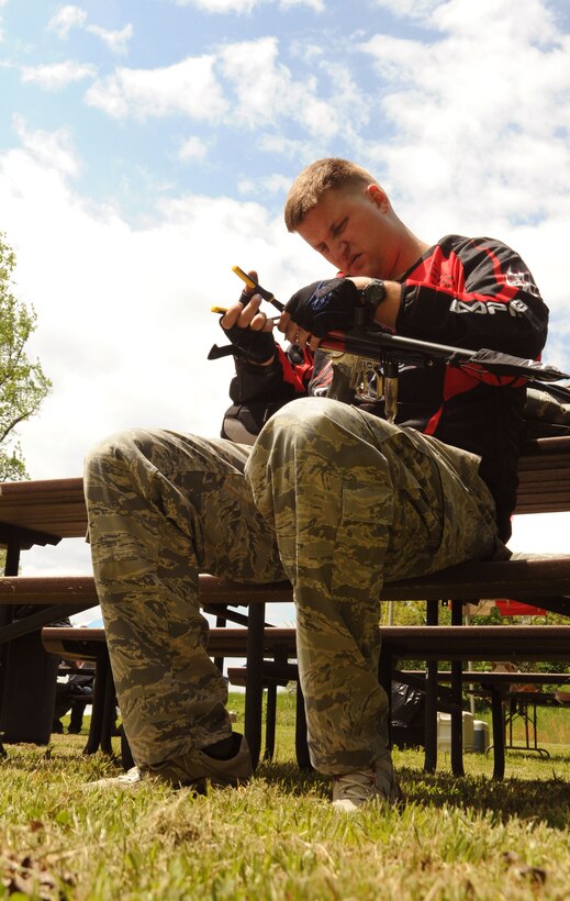 Staff Sgt. Brandon Jewell, 11 Civil Engineer Squadron engineering apprentice, repairs his weapon after a round of paintball at the Andrews Paintball field April 29. Outdoor Recreation held an open house with free games and food in effort to attract more players this season. (U.S. Air Force photo by Senior Airman Torey Griffith)(released)