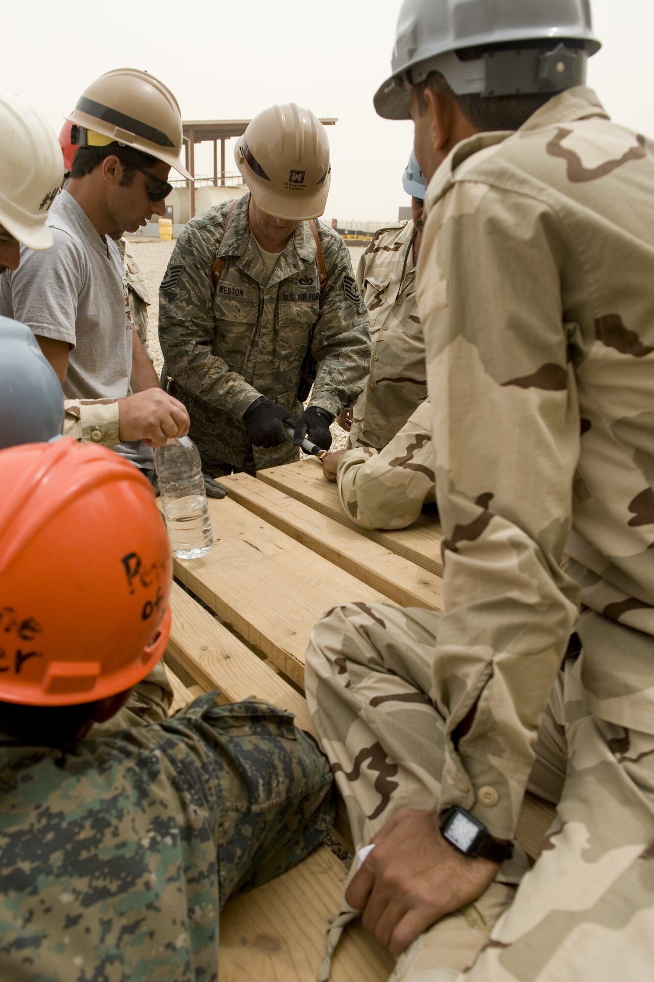ALI AIR BASE, Iraq -- Tech. Sgt. Randall Weston, 467th Expeditionary Prime Base Emergency Engineer Force Squadron electrical systems craftsman, shows Iraqi students how to strip insulation off a power distribution cable April 20. The students were part of a prime power class designed to teach Iraqi servicemembers how to generate, maintain and distribute power in order to operate their bases after the U.S. withdrawal scheduled for Dec. 31, 2011. Sergeant Weston is deployed from the 436th Civil Engineer Squadron, Dover Air Force Base, Del., and is a native of Fort Wayne, Ind. (U.S. Air Force photo by Staff Sgt. Levi Riendeau)
