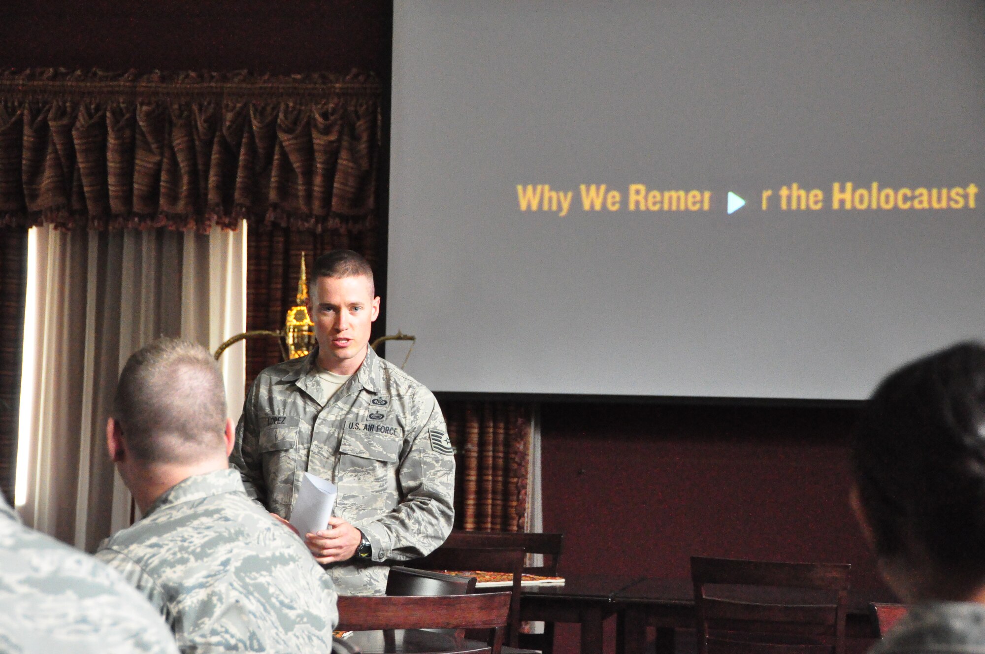 Tech. Sgt. Michael Lopez, Holocaust Day of Remembrance chair, addresses the crowd gathered May 1 at an undisclosed location in Southwest Asia. During the ceremony, deployed military members watched a video and heard remarks about the dangers of apathy in the face of others’ suffering.  Sergeant Lopez is deployed from Hill AFB, Utah, and currently assigned to the 71st Expeditionary Air Control Squadron here. (U.S. Air Force photo/Master Sgt. Michael Hammond)    