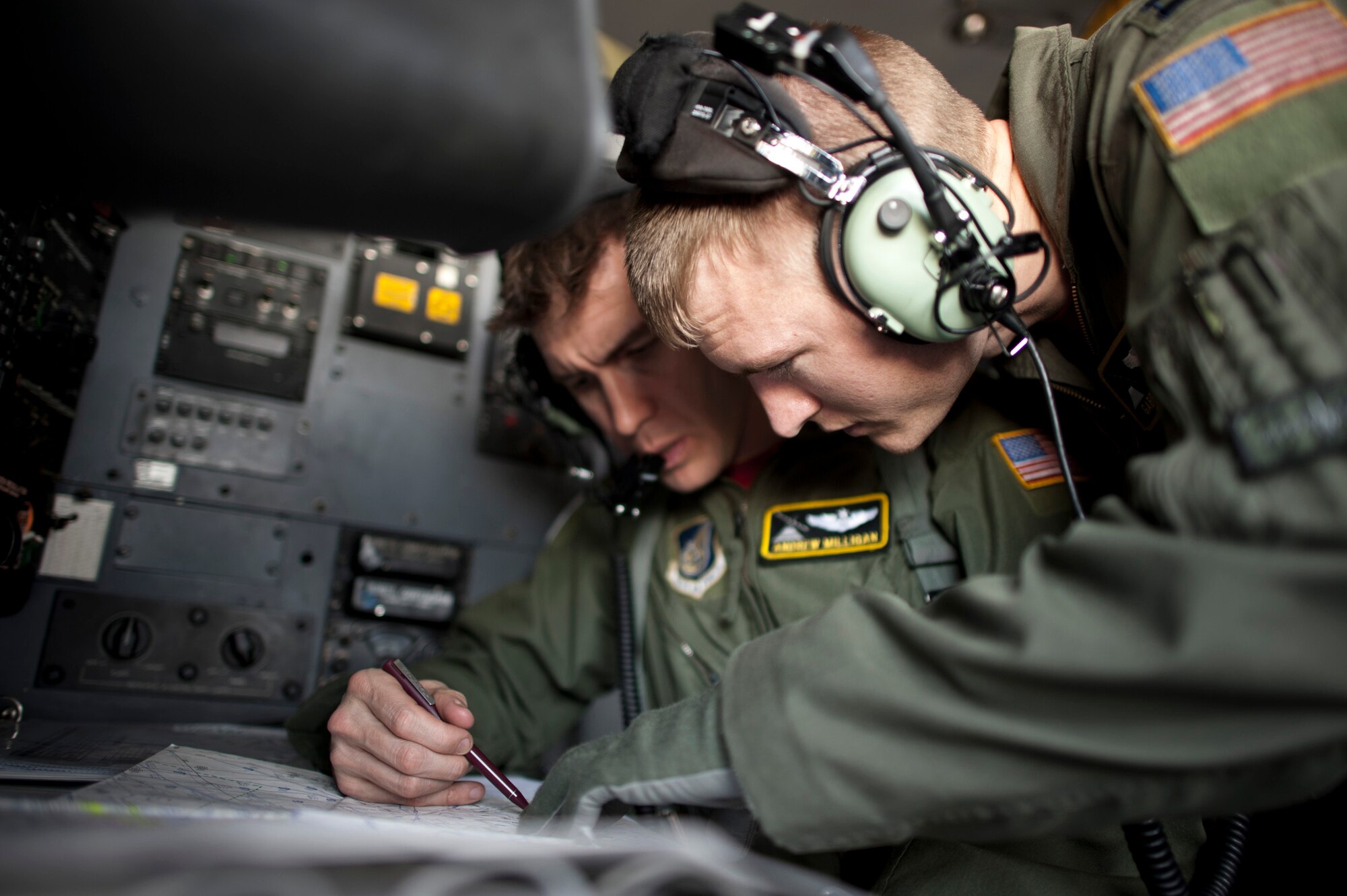 PACIFIC OCEAN -- Capt. Gabe Frusha, 36th Airlift Squadron C-130 Hercules pilot, looks over a map with Capt. Andrew Milligan, 36th AS navigator, over the Pacific Ocean April 29, 2011. The C-130 crew dropped seven Davis Drifter Buoys off the eastern coast of Japan to help Japanese and American scientists monitor ocean currents. (U.S. Air Force photo/Staff Sgt. Samuel Morse)