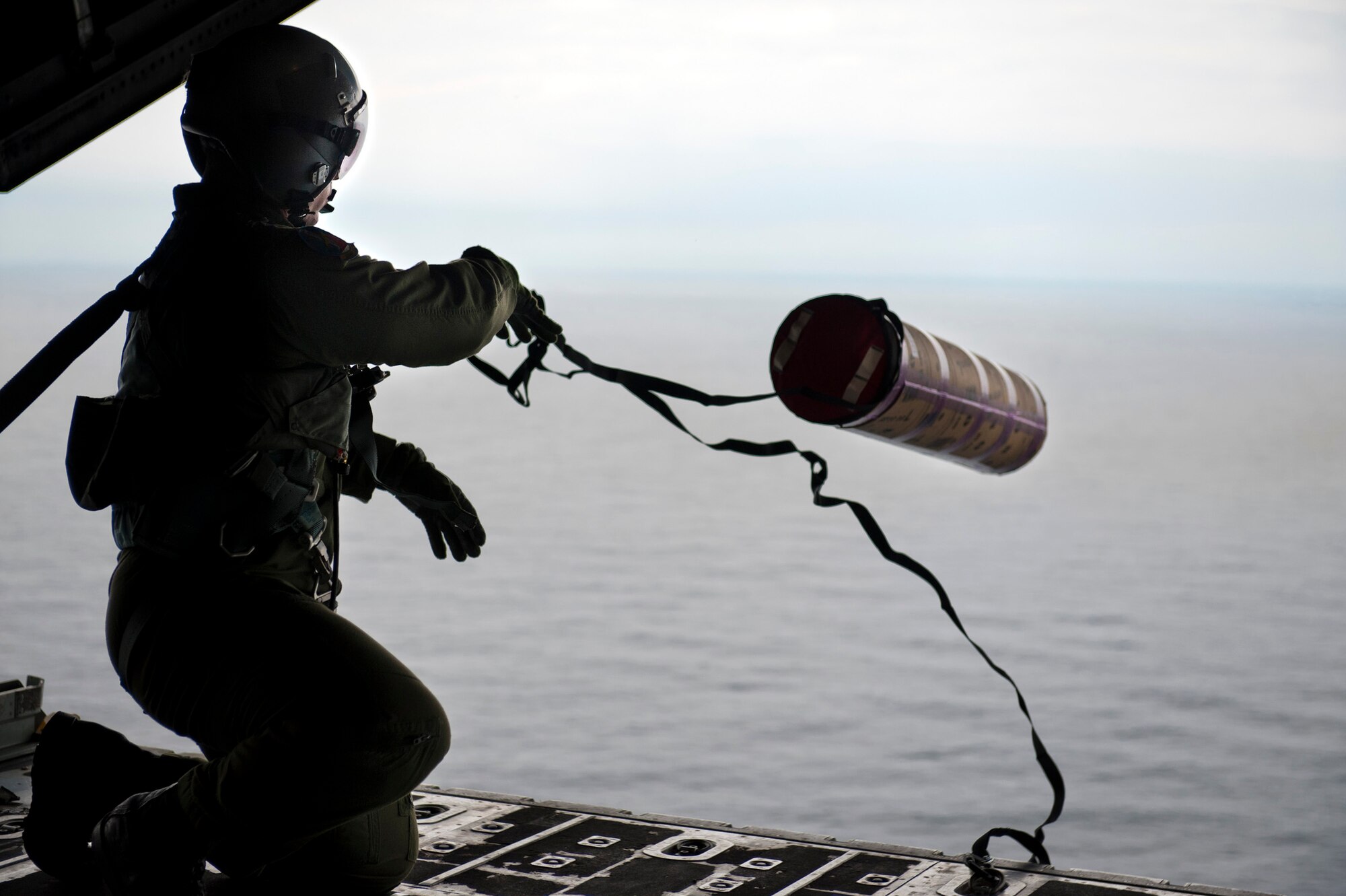 PACIFIC OCEAN -- Staff Sgt. Blake Landry 36th Airlift Squadron loadmaster deploys a Davis Drifter Buoy from a C-130 Hercules off the eastern coast of Japan, April 29, 2011. The C-130 crew dropped seven buoys off the eastern coast of Japan to help Japanese and American scientists monitor ocean currents. (U.S. Air Force photo/Staff Sgt. Samuel Morse)