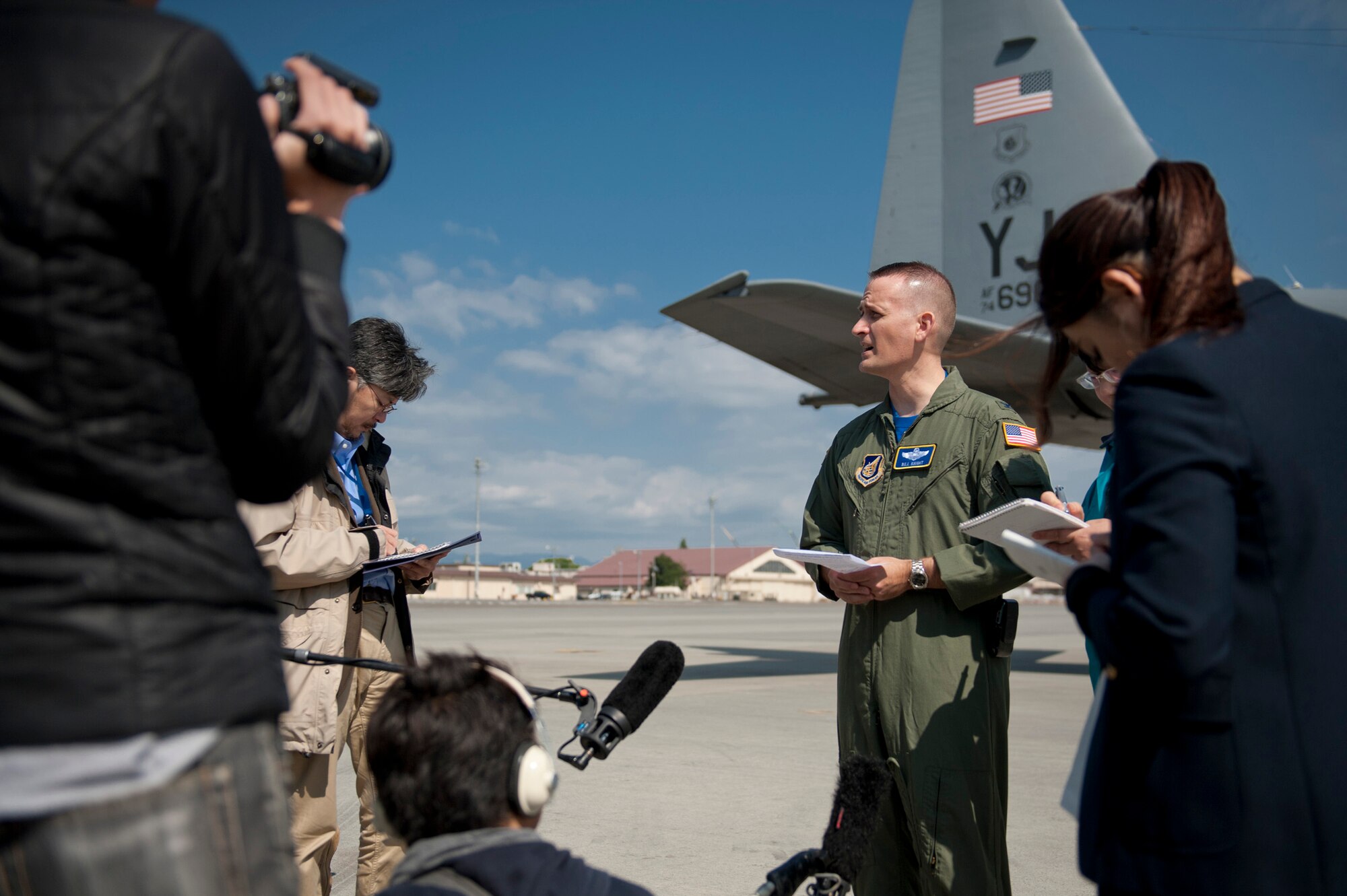 YOKOTA AIR BASE, Japan -- Col. Bill Knight, 374th Airlift Wing vice commander, answers questions from Japanese media in front of a C-130 Hercules on the flightline at Yokota Air Base, Japan, April 29, 2011. The C-130's crew dropped seven Davis Drifter Buoys off the eastern coast of Japan to help Japanese and American scientists monitor ocean currents. (U.S. Air Force photo/Staff Sgt. Samuel Morse)