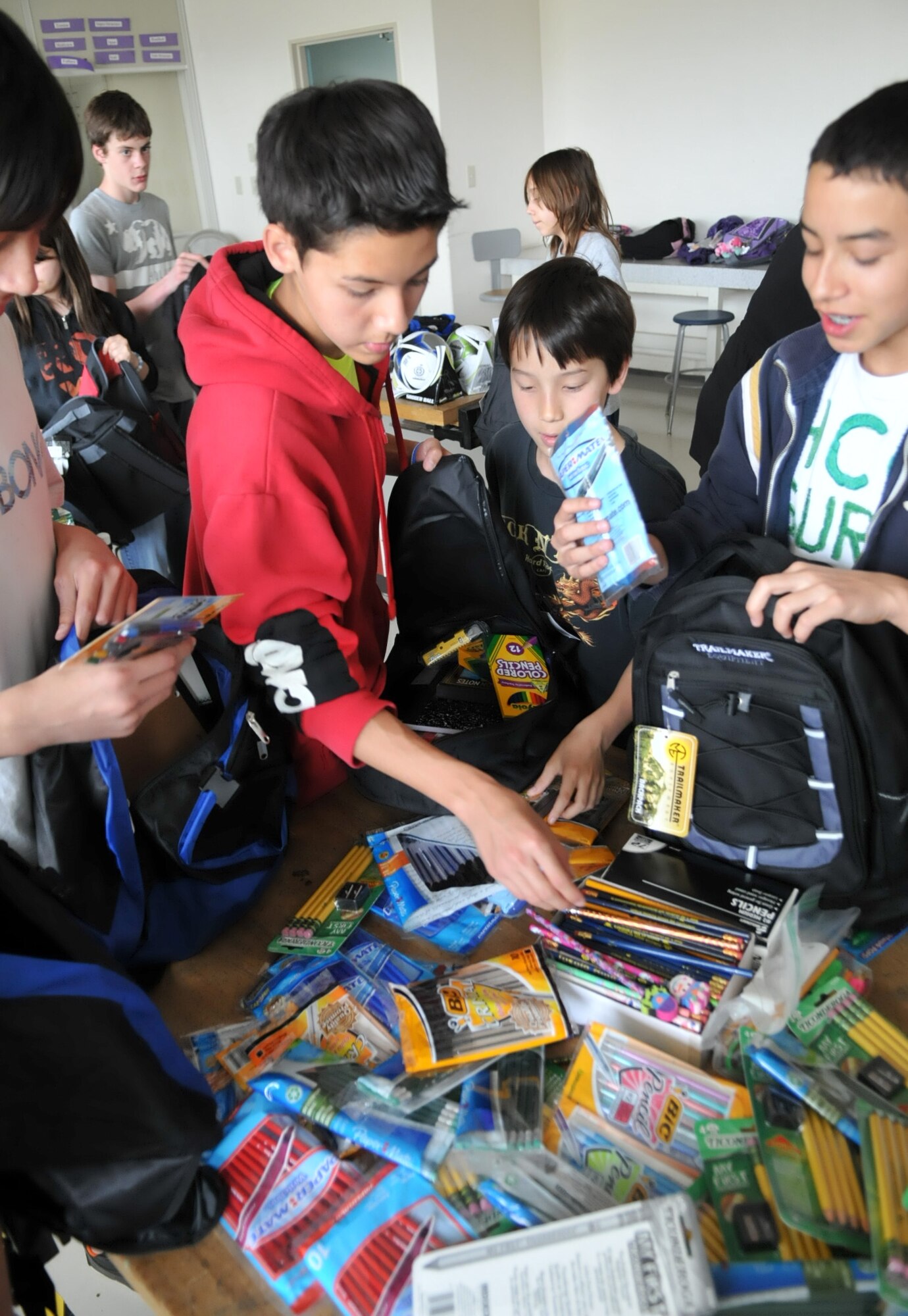 YOKOTA AIR BASE, Japan -- National Jr. Honor Society students, along with Roots and Shoots students at Yokota Middle School, place pens, pencils and other school supplies in backpacks at Yokota Air Base, Japan, April 27, 2011. The students provided school supplies to Japanese students affected by the natural disaster in northern Japan. (U.S. Air Force photo/Airman 1st Class Krystal M. Garrett) 