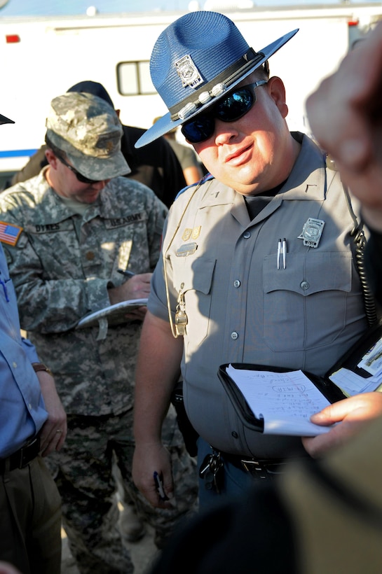 Mississippi Highway Safety Patrol Trooper Brian C. Mobley briefs citizens about curfew times intended to enhance safety and protect property following a tornado that struck Smithville, Miss., April 28, 2011.