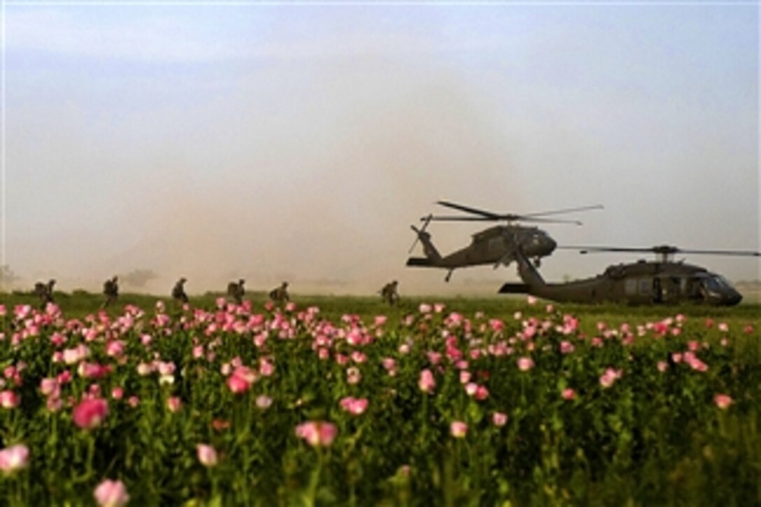U.S. Special Operations service members with Special Operations Task Force South board two UH-60 Black Hawk helicopters following a clearing operation in Panjwa'i district in Kandahar province, Afghanistan, on April 25, 2011.  The operation, led by Afghan commandos resulted in the removal of Taliban propaganda material and three suspected insurgents detained.  