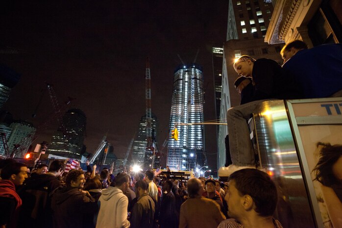 A crowd cheers and chants in excitement at the corner of Vesey St. and Liberty St. next to Ground Zero after hearing that Osama Bin Laden is dead. Bin Laden planned the attacks, Sept 11, 2001 and has been hunted by American forces in the years since. He was killed by a raid in Abbottabad, Pakistan near the country's capital. The Freedom Tower, the skyscraper being built where the World Trade Center towers once stood, is now 60 stories tall and was lit up and visible from the street. Eventually the Freedom Tower will be the tallest building in the country.