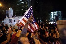 A crowd cheers and chants in excitement at the corner of Vesey St. and Liberty St. next to Ground Zero after hearing that Osama Bin Laden is dead. Bin Laden planned the attacks, Sept 11, 2001 and has been hunted by American forces in the years since. He was killed by a raid in Abbottabad, Pakistan near the country's capital. The Freedom Tower, the skyscraper being built where the World Trade Center towers once stood, is now 60 stories tall and was lit up and visible from the street. Eventually the Freedom Tower will be the tallest building in the country.