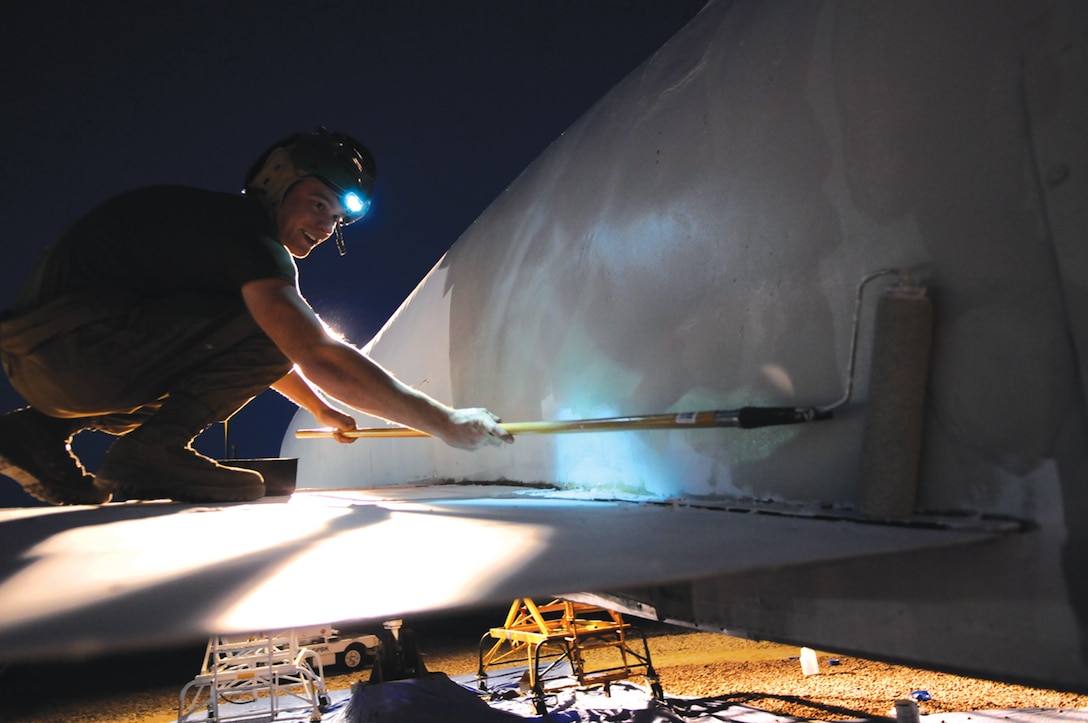 Lance Cpl. Casey Daves, Marine Aviation Logistics Squadron 13 airframes mechanic, adds a fresh coat of paint to a static display of an F-4 Phantom II aircraft at the station's main gate May 2, 2011. Ten MALS-13 Marines have been working on the display for approximately three weeks, to include panel replacement, debris removal and a fresh paint job. “I think we have a very tasking job,” said Sgt. Richard Snelling, MALS-13 power plant mechanic. “This thing was disgusting and we made it look good.” The Marine Corps received its first batch of Phantoms in 1962 at the former Marine Corps Air Station in El Toro, Calif. The last Phantom saw its end in 1992. “Being part of the restoration of one of the birds the Marine Corps has flown is a rare opportunity with a pretty good honor to it,” said Snelling. “These aircraft are the first things people see when they drive by here and the first thing that catches their eye. Being part of the restoration is probably something I won’t get to do again and something not a lot of people get to be a part of.”