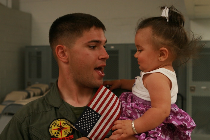 Naval Support Facility Indian Head, Md. – Cpl. Kevin M. Halfman, Initial Response Force A, Chemical Biological Incident Response Force, greats his little girl after returning home from a month long deployment in support of Operation Tomodachi. The Marines of IRF A Deployed to Japan after a catastrophic earthquake and soon after tsunami shook the country and critically damaging the nuclear power plant Fukushima Dai-ichi. (Photo By Sgt. Frances L. Goch)(Released)