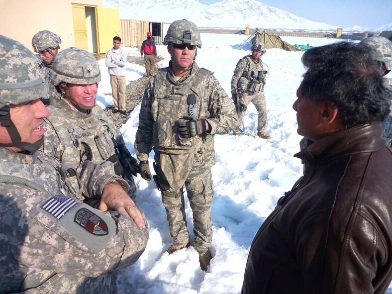 Col. Bob Wicks, commander of RSC-Capital (center), along with Maj. Gen. James B. Mallory, deputy commanding general, NTM-A/CSTC-A (left), Brig. Gen. John McGuiness, then deputy commander, Regional Support, and Rashid Joyaa (right), president, Global Engineering & Consulting Services, discuss the status of Forward Operating Base Hussein Khut Feb. 15. (Photo by Jon Connor)