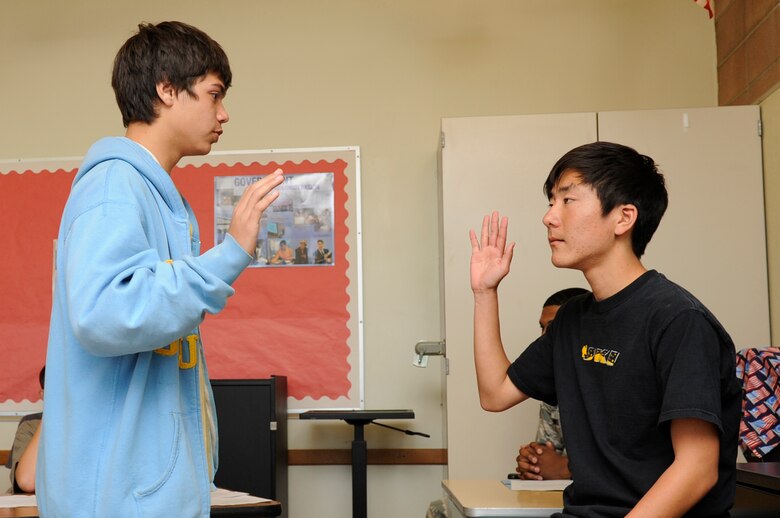 VANDENBERG AIR FORCE BASE, Calif. - Jacob Lizama, an 8th grader enrolled at the Vandenberg Middle School, swears in the defendant Eugene Choi, an 8th grader at VMS, during a mock trial for Public Law Day at the VMS here Friday, April 29, 2011. Public Law Day was enacted by President Dwight D. Eisenhower to enable the public to respect the law and protect the democratic way of life. (U.S. Air Force photo/Senior Airman Lael Huss)


 
    