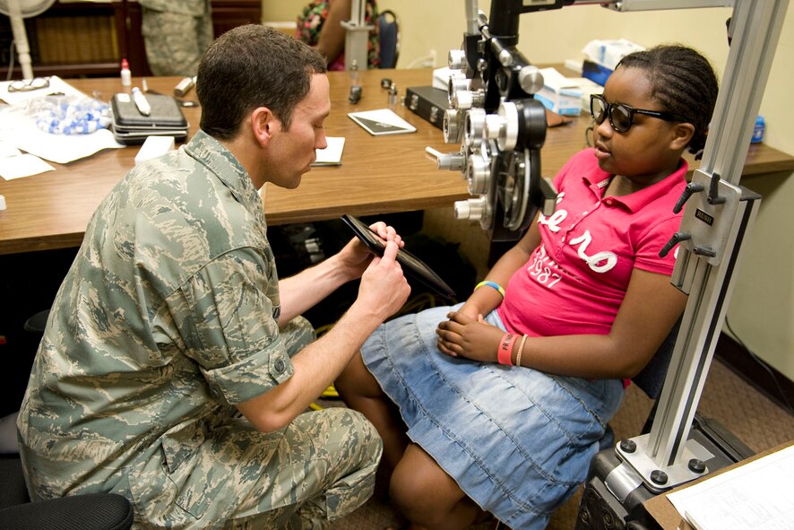 HAYNEVILLE, Ala. - Capt. Andrew Adamich, an optometrist from the 176th Medical Group, Alaska Air National Guard, performs a depth perception test on his patient, Princess Wright, age 11, of Troy, Ala., May 3, 2011. Adamich and about 30 other members from the 176th Wing are in Alabama for an Innovative Readiness Training (IRT) mission. The IRT program allows for real world training opportunities for military personnel while providing needed services to under-served communities in the United States. Alaska Air National Guard photo by Master Sgt. Shannon Oleson.