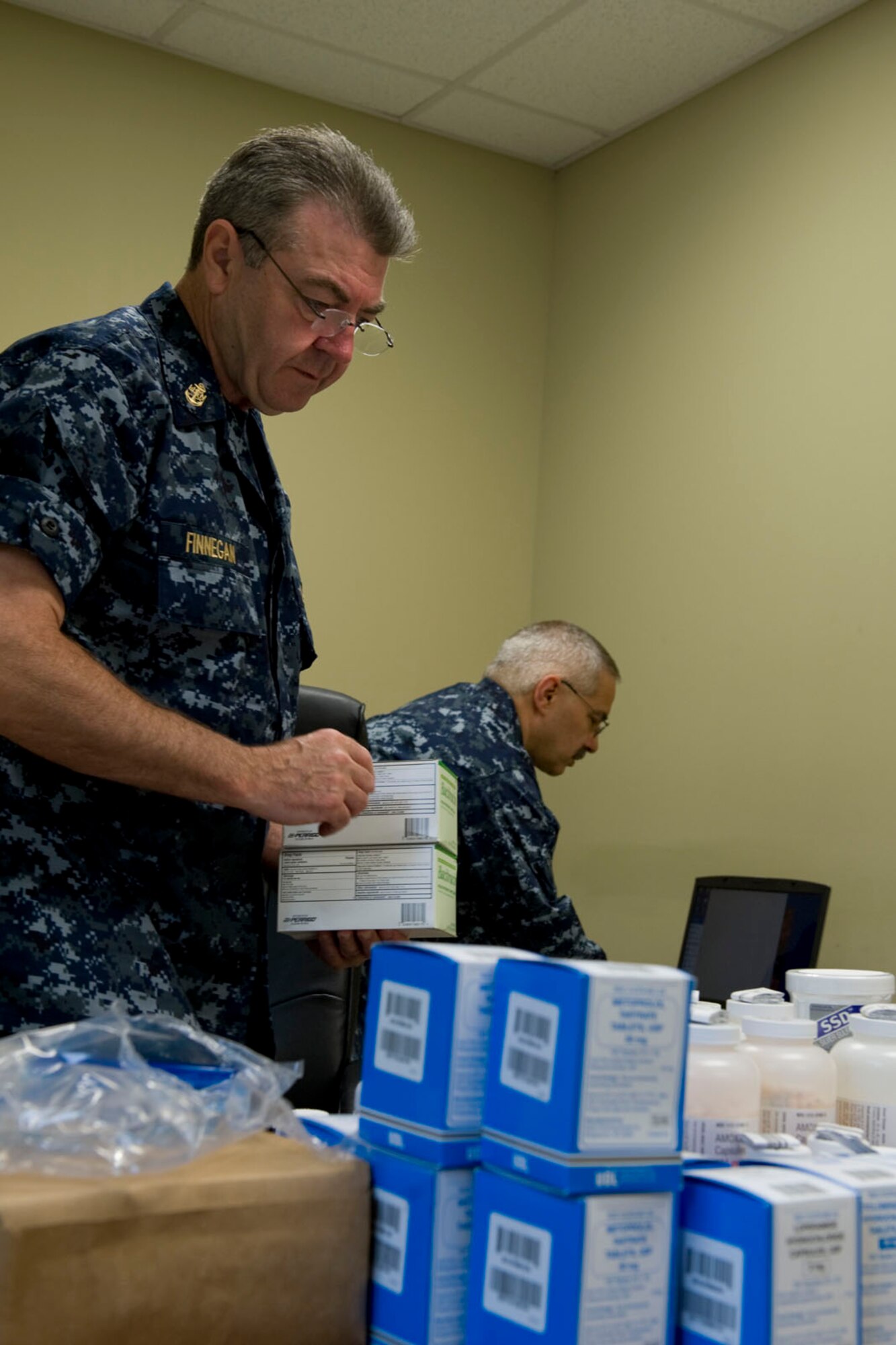 HAYNEVILLE, Ala. - Chief Petty Officer Joseph Finnegan, a pharmacy technician, from the Navy Operation Support Center, Pittsburgh, Pa., and Navy Capt. Edward Cretaro, a pharmacist, from the Navy Operation Support Center, Scheneectady, N.Y., organize pharmacy supplies, May 5, 2011. Finnegan and Cretaro are in Alabama along with about sixty other medical professional from numerous military components and services for an Innovative Readiness Training (IRT) mission. The IRT program allows for real world training opportunities for military personnel while providing needed services to under-served communities in the United States. Alaska Air National Guard photo by Master Sgt. Shannon Oleson.