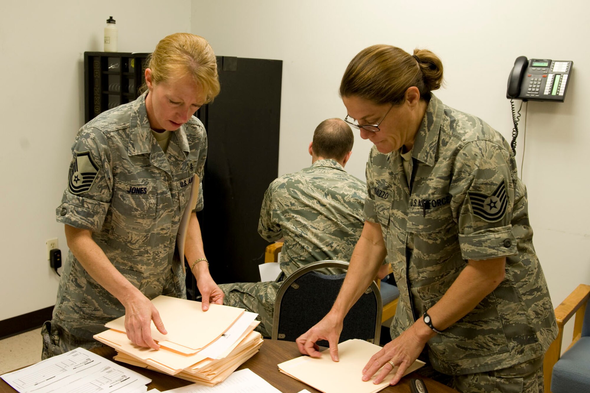 HAYNEVILLE, Ala. - Master Sgt. Pauline Jones, a medical logistics technician, from the 176th Medical Group, Alaska Air National Guard and Tech. Sgt. Jan Randazzo, a medical administration technician, from the 131st Medicial, Missouri Air National Guard prepare patient forms, May 3, 2011.  Jones and Randazzo are in Alabama for an Innovative Readiness Training (IRT) mission. The IRT program allows for real world training opportunities for military personnel while providing needed services to under-served communities in the United States. Alaska Air National Guard photo by Master Sgt. Shannon Oleson.